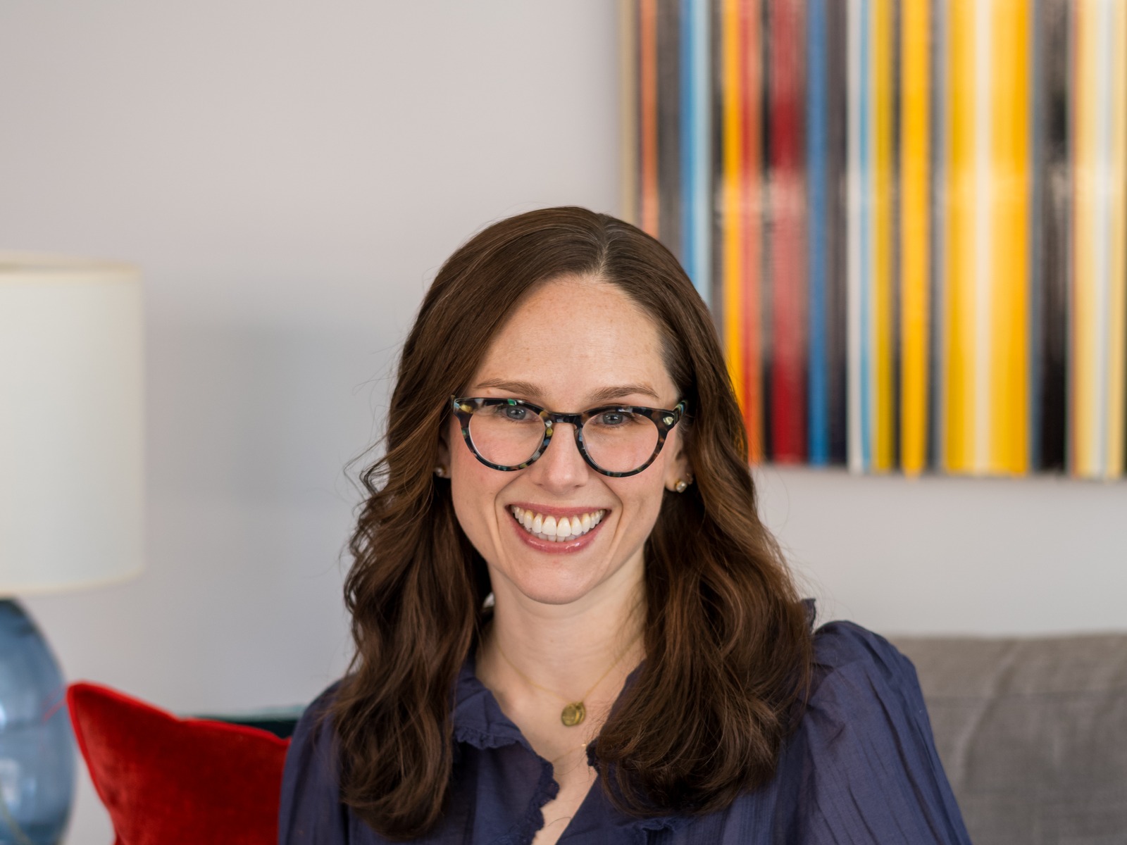 Catey, seated on a gray couch