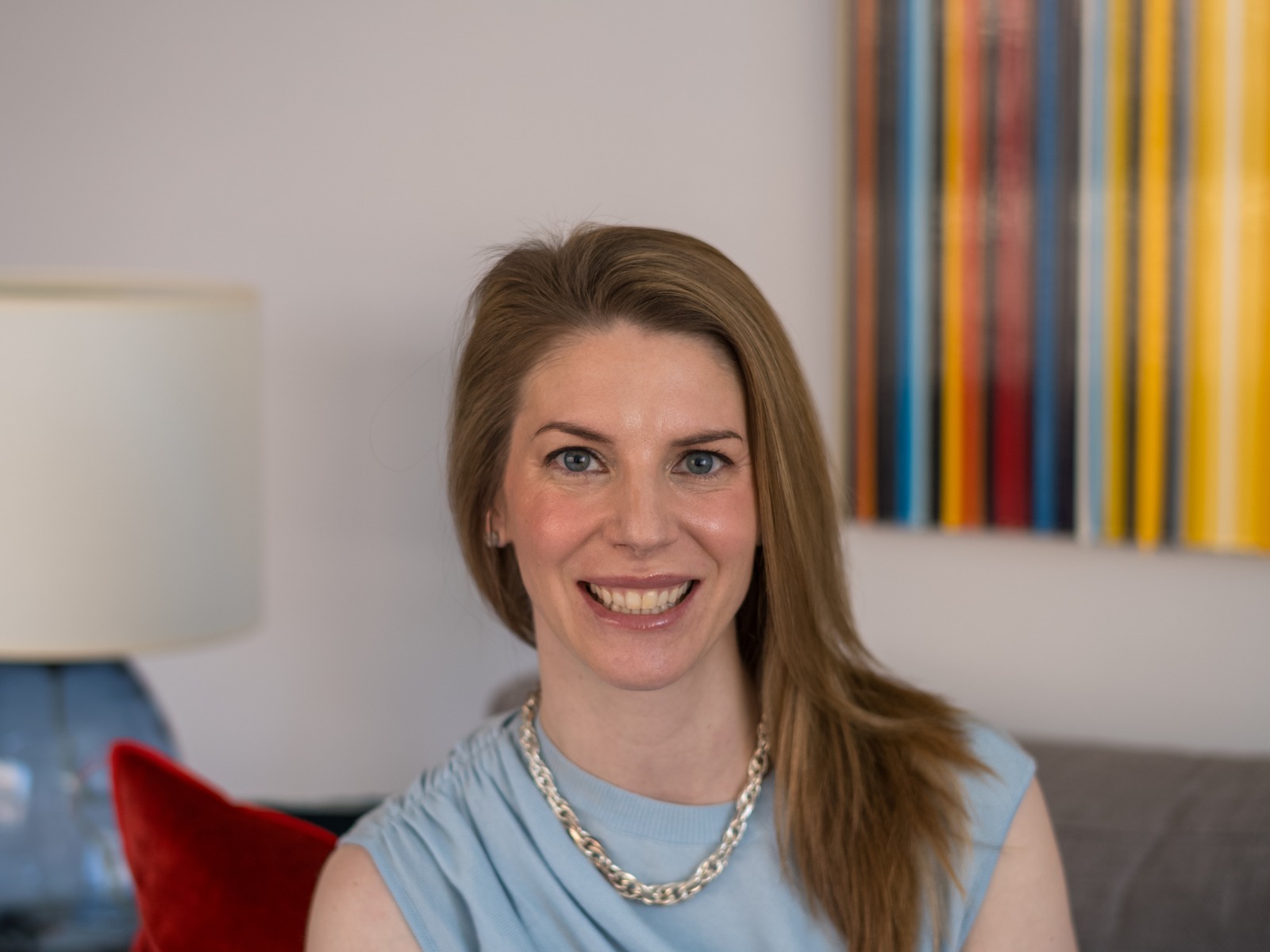 Katie, seated on a gray couch